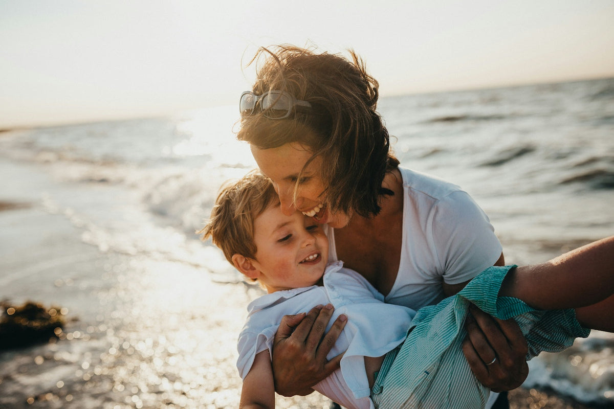 Mom with her child enjoying the beach