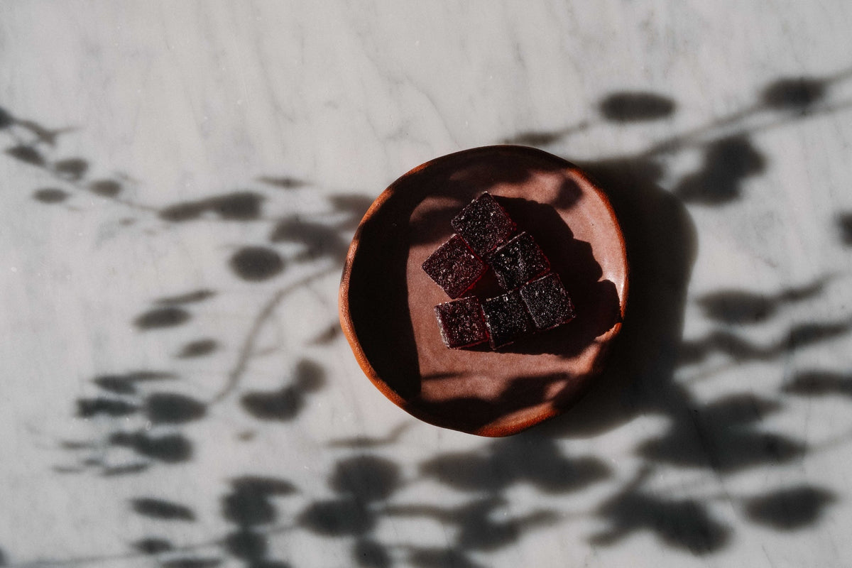 Dragon Hemp Calming Gummies on a stone apothecary tray for daily anxiety support