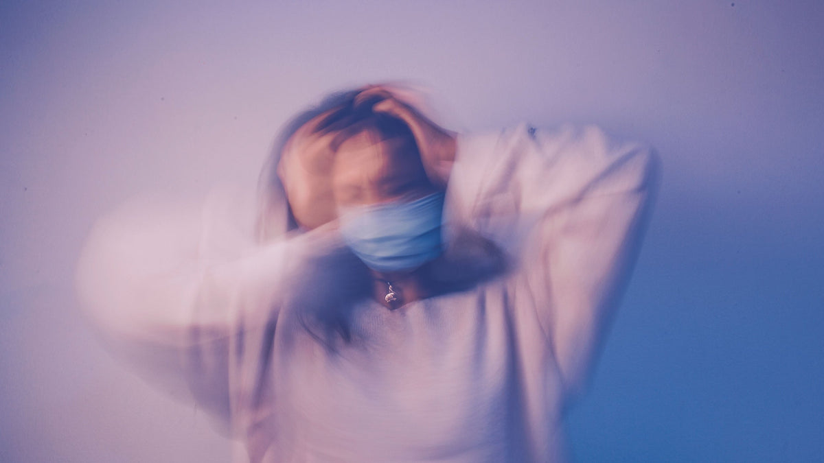 Person pausing to breathe before a social gathering, easing anticipatory social anxiety